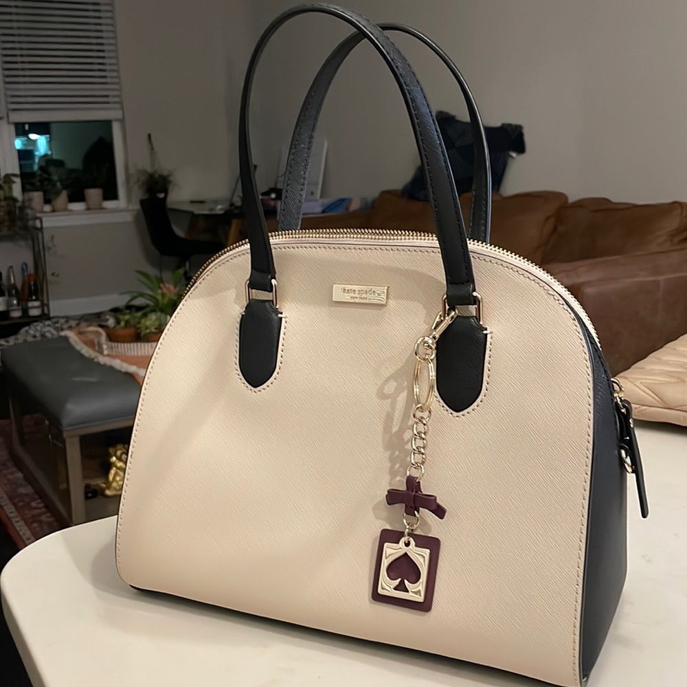 Very elegant Kate Spade Handbag in cream with black detailing.